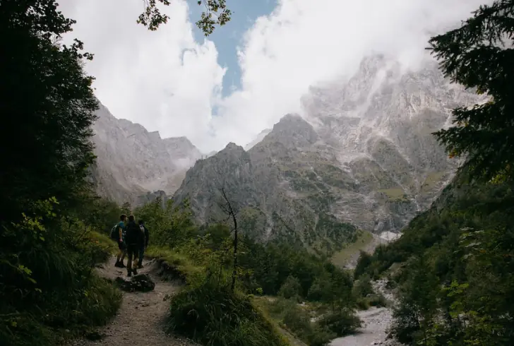 Group of Solo Travelers Hiking in a Mountain Landscape